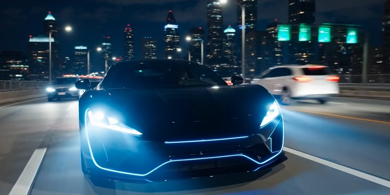 Sports car with blue lights driving on a city highway at night