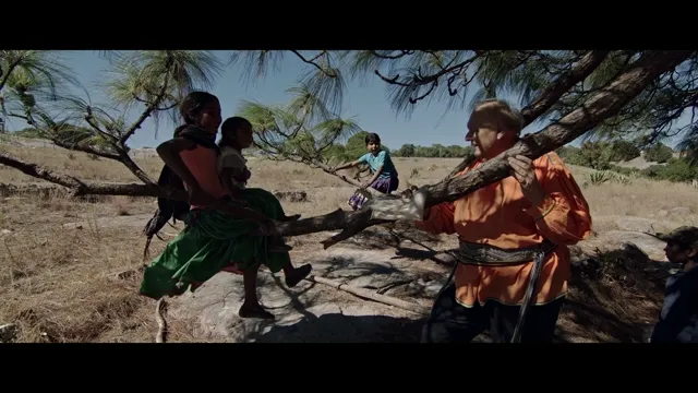 Children playing under a tree in a dry rural landscape in a Grupo México film