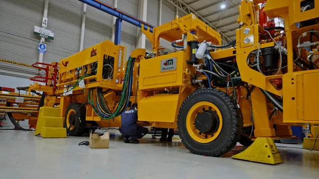 Yellow MacLean underground mining machine on the factory floor in a corporate video